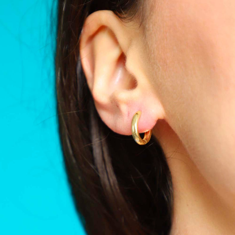 Gold Hoop Earrings Worn On A Model.jpg