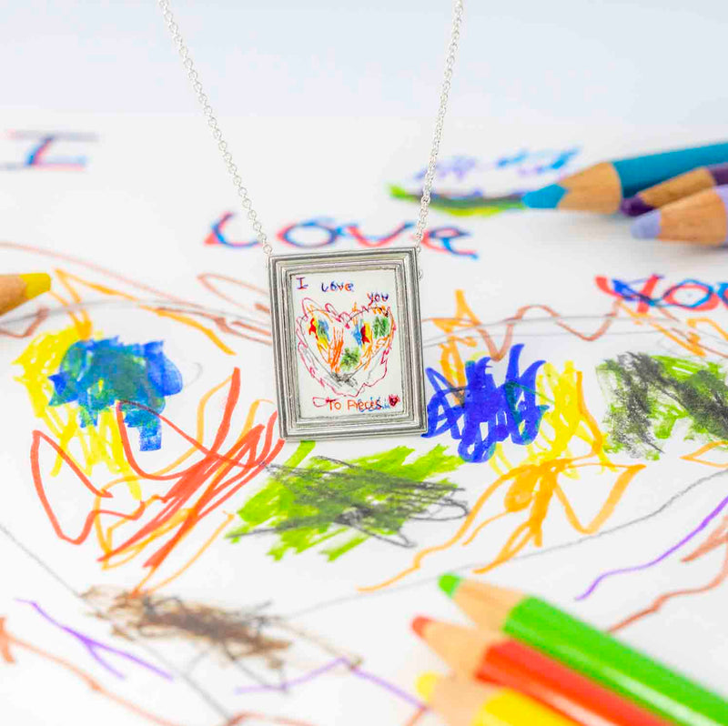 Framed Personalised Necklace with the Childs drawing that inspired it as a backdrop